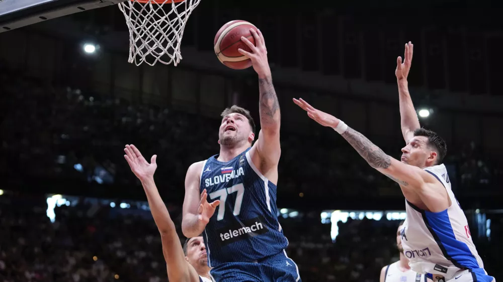 Slovenia's Luka Doncic tries to score against Greece, during an Acropolis tournament basketball match, at the Peace and Friendship indoor stadium at Athens' port city of Piraeus, Saturday, July 6, 2024. (AP Photo/Petros Giannakouris)