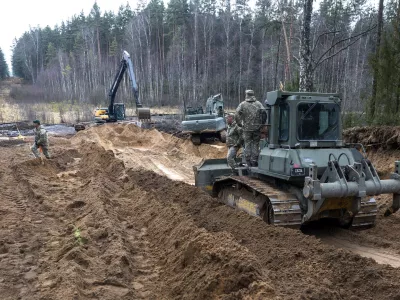 Recovery efforts continue for four missing U.S. soldiers near the spot where their Hercules armored vehicle was found submerged at a training range in Pabrade, north of the capital Vilnius, Lithuania on Thursday, March 27, 2025. (AP Photo/Mindaugas Kulbis)