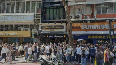 People who evacuated from buildings following earthquake in Bangkok, Thailand, Friday, March 28, 2025. (AP Photo/Chutima Lalit)