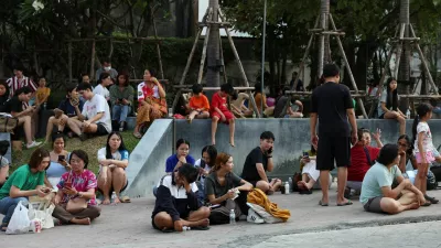 People sit on the pavement after a strong earthquake struck central Myanmar on Friday, earthquake monitoring services said, which affected Bangkok as well with hundreds of people pouring out of buildings in the Thai capital in panic after the tremors, in Bangkok, Thailand, March 28, 2025. REUTERS/Chalinee Thirasupa