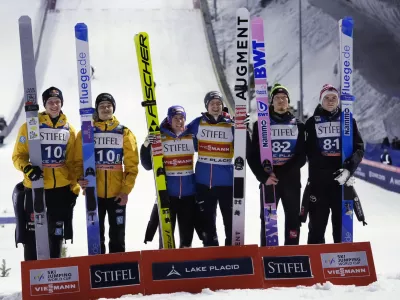 CORRECTS ORDER OF FINISH FOR NORWAY AND GERMANY - GERMAN TEAM FINISHED IN SECOND - Winners Stefan Kraft and Michael Hayboeck, center of Austria, stand with third-place Johann Andre Forfang and Marius Lindvik, right, of Norway, and second-place Andreas Wellinger and Philipp Raimund, of Germany, after the men's large hill super team World Cup ski jumping competition, Saturday, Feb. 10, 2024, in Lake Placid, N.Y. (AP Photo/Robert F. Bukaty)