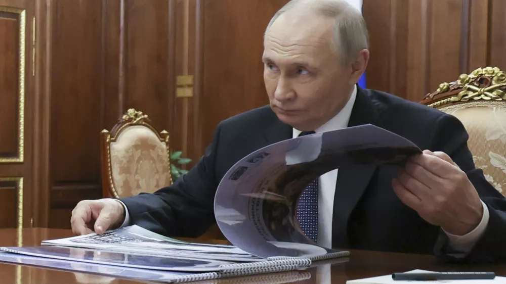 Russian President Vladimir Putin attends a meeting with Leningrad Region Governor Alexander Drozdenko at the Kremlin in Moscow, Russia, Friday, March 28, 2025. (Vyacheslav Prokofyev, Sputnik, Kremlin Pool Photo via AP)