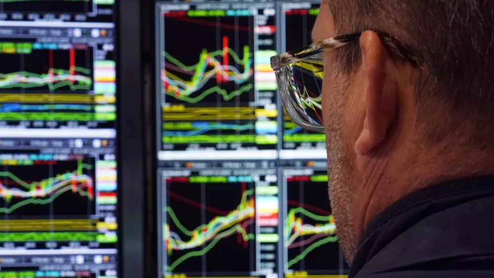 A specialist works at his post on the floor of the New York Stock Exchange, Wednesday, March 12, 2025. (AP Photo/Richard Drew)
