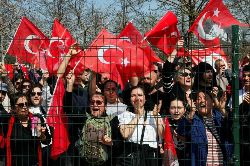 People wave Turkish flags during a rally to protest against the arrest of Istanbul Mayor Ekrem Imamoglu as part of a corruption investigation, in Istanbul, Turkey, March 29, 2025. REUTERS/Umit Bektas