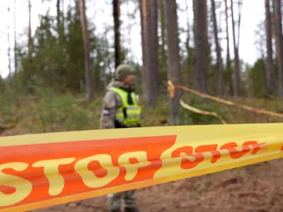 A soldier stands next to cordon tape at the scene of a rescue operation at Pabrade training ground, in Lithuania, March 31, 2025. Lithuanian Armed Forces/Handout via REUTERS ATTENTION EDITORS - THIS IMAGE HAS BEEN SUPPLIED BY A THIRD PARTY. NO RESALES. NO ARCHIVES. MANDATORY CREDIT