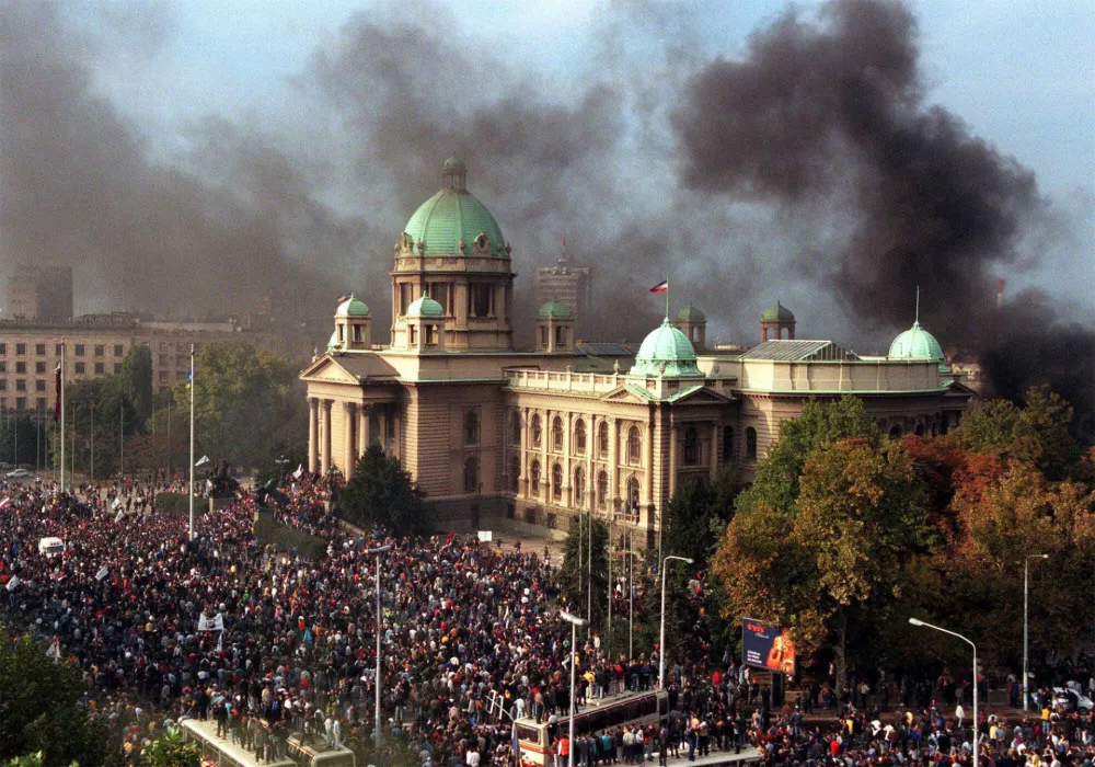 ** FILE ** TO GO WITH STORY SLUG: SERBIA-FIVE YEARS ON GLANCE BY KATARINA KRATOVAC -- Smoke rises from the Yugoslav federal parliament in this Thursday, Oct. 5, 2000 file photo in Belgrade. Angry crowds gathered in front of the parliament while columns of protesters streamed into the capital for a mass rally intended as the final push against embattled president Slobodan Milosevic. (AP Photo / Zeljko Safar)