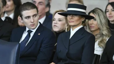 Barron Trump and first lady Melania Trump listen as President Donald Trump delivers remarks after being sworn in during the 60th Presidential Inauguration in the Rotunda of the U.S. Capitol in Washington, Monday, Jan. 20, 2025. (Saul Loeb/Pool photo via AP)