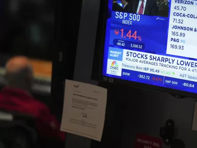 People work on the floor at the New York Stock Exchange in New York, Monday, March 31, 2025. (AP Photo/Seth Wenig)