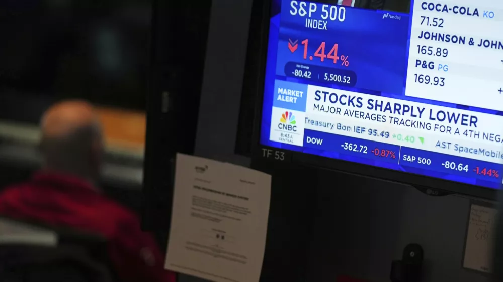 People work on the floor at the New York Stock Exchange in New York, Monday, March 31, 2025. (AP Photo/Seth Wenig)