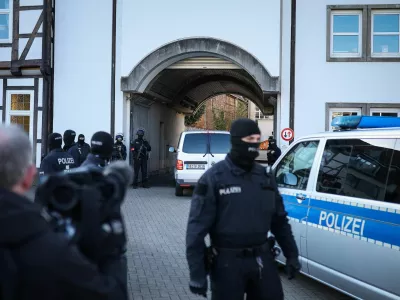 A transport vehicle carrying Daniela Klette, accused of being one of the last surviving members of the Red Army Faction group, who was arrested after decades on the run for armed robbery and attempted murder, is escorted by police cars as it arrives at the compound of the court builing on April 1, 2025 in Celle, northern Germany, as her trial continues.  RONNY HARTMANN/Pool via REUTERS