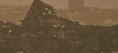 Buildings that were destroyed during the Israeli ground and air operations stand in northern of Gaza Strip as seen from southern Israel, Tuesday, April 1, 2025. (AP Photo/Leo Correa)