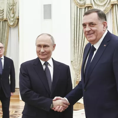 Russian President Vladimir Putin, center, and Bosnian Serb President Milorad Dodik shake hands during their meeting at the Kremlin in Moscow, Russia, Tuesday, April 1, 2025. (Mikhail Tereshchenko, Sputnik, Kremlin Pool Photo via AP)