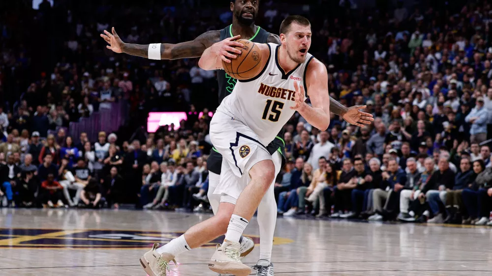 Apr 1, 2025; Denver, Colorado, USA; Denver Nuggets center Nikola Jokic (15) drives to the basket against Minnesota Timberwolves forward Julius Randle (30) in the fourth quarter at Ball Arena. Mandatory Credit: Isaiah J. Downing-Imagn Images