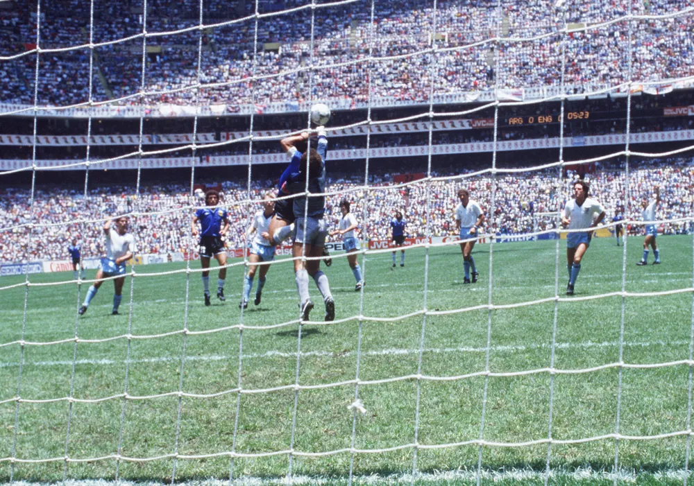 Diego Maradona, Argentina, scoring the legendary "Hand of God" goal during the England - Argentina (1:2) match at the 1990 FIFA World Cup in Mexico. Photo by: Sven Simon/picture-alliance/dpa/AP Images