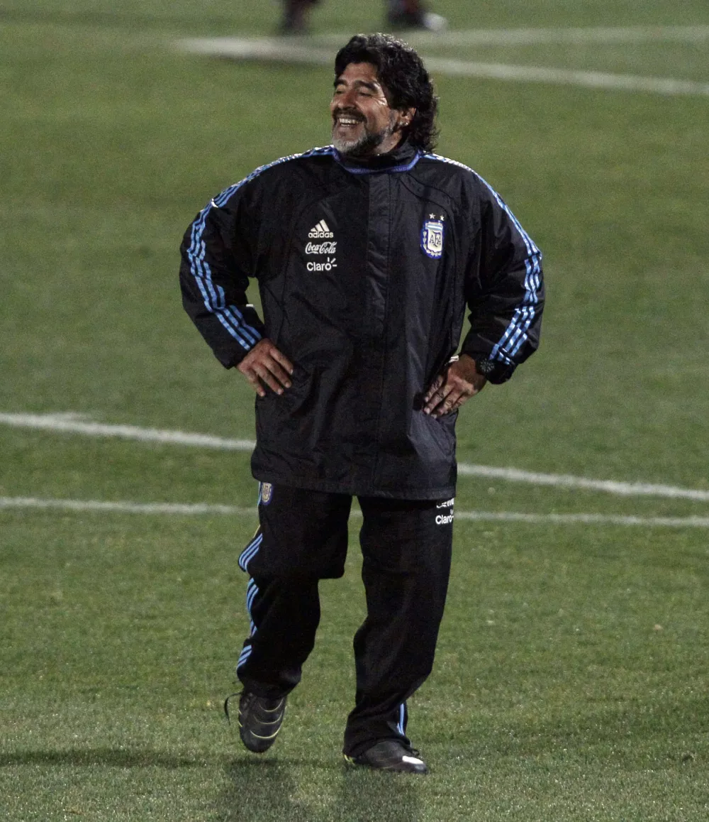 Argentina's soccer team coach Diego Maradona, left, smiles during a practice in Pretoria, South Africa, Thursday, July 1, 2010. Argentina will play against Germany in a World Cup quarterfinal match on July 3. (AP Photo/Ricardo Mazalan)