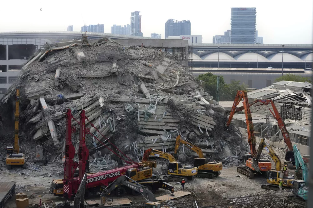 Heavy machineries are deployed to clear the rubble from an under construction high-rise building that collapsed after Friday's earthquake in Bangkok, Thailand, Wednesday, April 2, 2025. (AP Photo/Manish Swarup)