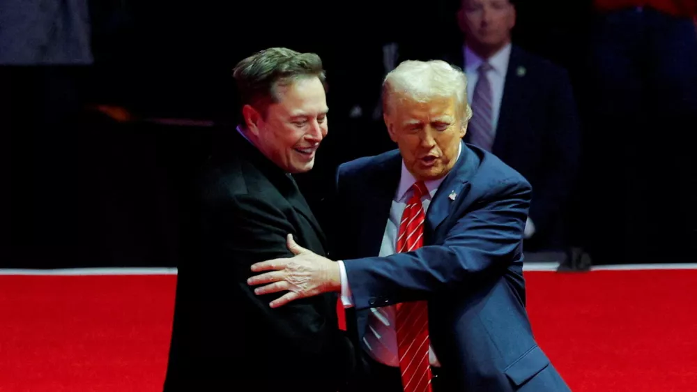 FILE PHOTO: U.S. President-elect Donald Trump greets Tesla CEO and X owner Elon Musk during a rally the day before Trump is scheduled to be inaugurated for a second term, in Washington, U.S., January 19, 2025. REUTERS/Brian Snyder/File Photo