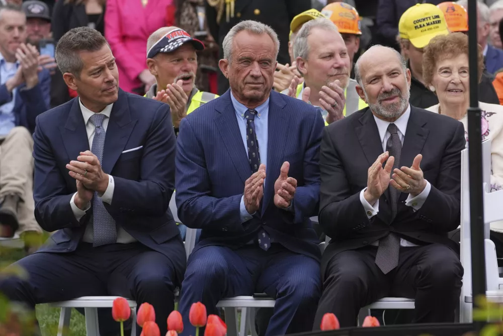 Transportation Secretary Sean Duffy, left, Health and Human Services Secretary Robert F. Kennedy Jr. and Commerce Secretary Howard Lutnick listen as President Donald Trump speaks during an event to announce new tariffs in the Rose Garden of the White House, Wednesday, April 2, 2025, in Washington. (AP Photo/Evan Vucci)
