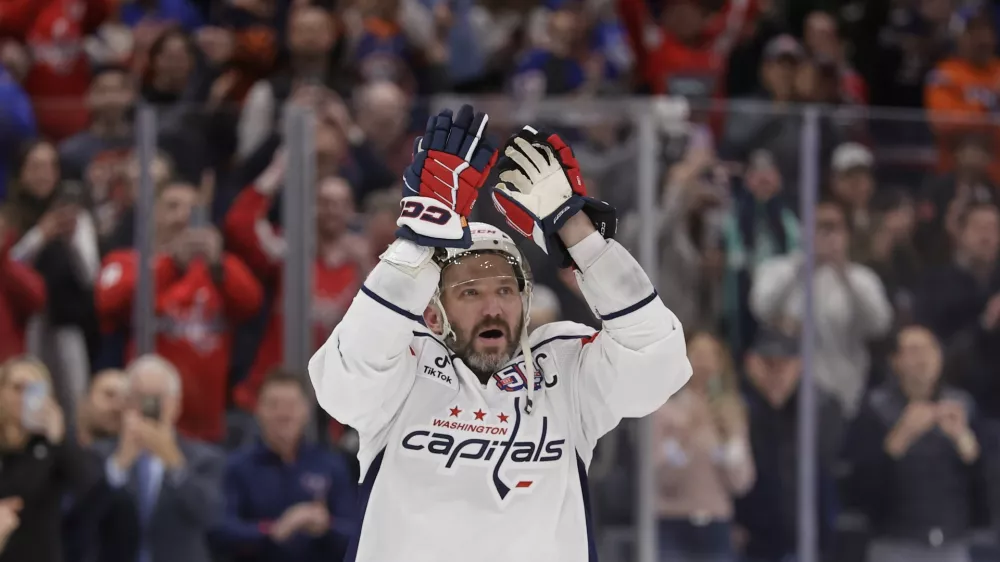 Washington Capitals left wing Alex Ovechkin (8) celebrates after scoring his 895th career goal during the second period of an NHL hockey game against New York Islanders in Elmont, N.Y., Sunday, April 6, 2025. (AP Photo/Adam Hunger)