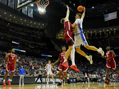 Mar 29, 2025; Newark, NJ, USA; Duke Blue Devils forward Cooper Flagg (2) goes up to dunk the ball against Alabama Crimson Tide forward Grant Nelson (4) during the second half in the East Regional final of the 2025 NCAA tournament at Prudential Center. Mandatory Credit: Robert Deutsch-Imagn Images
