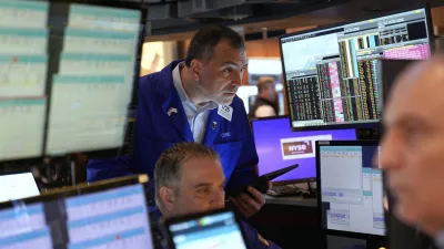 Traders, including Christopher Lagana, center, work on the floor at the New York Stock Exchange in New York, Wednesday, April 2, 2025. (AP Photo/Seth Wenig)