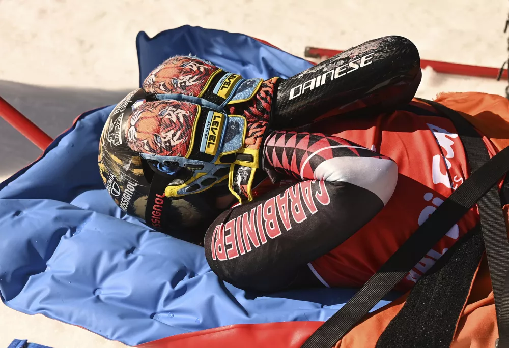 Overall World Cup skiing champion Italy's Federica Brignone is carried away on a toboga after she broke multiple bones in her left leg during a giant slalom crash at the Italian championships in the Lusia ski area, in Val di Fassa, Italy, Thursday, April 3, 2025. (AP Photo/Elvis Piazzi)