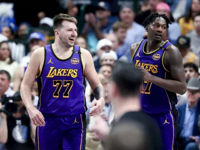 Apr 9, 2025; Dallas, Texas, USA; Los Angeles Lakers guard Luka Doncic (77) laughs with Los Angeles Lakers forward Dorian Finney-Smith (17) against the Dallas Mavericks during the second half at American Airlines Center. Mandatory Credit: Kevin Jairaj-Imagn Images