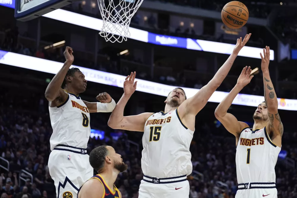 Denver Nuggets center Nikola Jokic (15) rebounds the ball during the second half of an NBA basketball game against the Golden State Warriors, Friday, April 4, 2025, in San Francisco. (AP Photo/Godofredo A. V&aacute;squez)