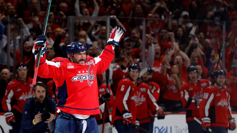 Apr 4, 2025; Washington, District of Columbia, USA; Washington Capitals left wing Alex Ovechkin (8) waves to the crowd from center ice after scoring his 894th career goal on a goal against the Chicago Blackhawks in the third period at Capital One Arena. Ovechkin tied Wayne Gretzky (not pictured) for the all time record for career goal with the goal. Mandatory Credit: Geoff Burke-Imagn Images   TPX IMAGES OF THE DAY