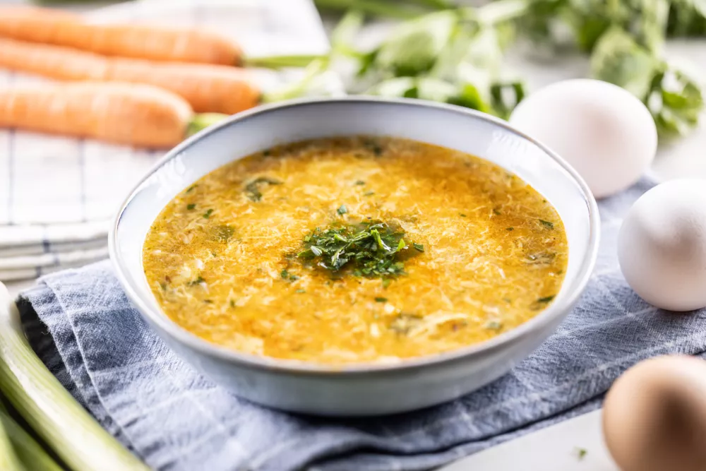 Egg and carrot soup in a bowl. Traditional Slovak egg and carrot soup. / Foto: Marianvejcik