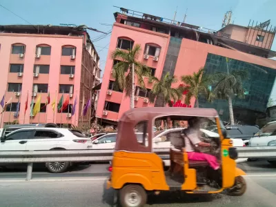Motorists ride past a damaged building after a strong earthquake struck central Myanmar, in Mandalay, Myanmar, March 28, 2025. REUTERS/Stringer   TPX IMAGES OF THE DAY