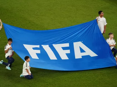 FILED - 26 November 2022, Qatar, Doha: children holding a banner with the inscription "FIFA" at the FIFA Qatar World Cup soccer match between France and Denmark at Stadium 974. Some rules by governing body FIFA on football transfers violate European Union law, the European Court of Justice has ruled. Photo: Mike Egerton/Press Association/dpa