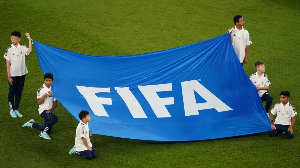 FILED - 26 November 2022, Qatar, Doha: children holding a banner with the inscription "FIFA" at the FIFA Qatar World Cup soccer match between France and Denmark at Stadium 974. Some rules by governing body FIFA on football transfers violate European Union law, the European Court of Justice has ruled. Photo: Mike Egerton/Press Association/dpa