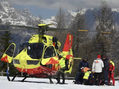 Italy's Federica Brignone is assisted before being flown by helicopter to an hospital, after she broke multiple bones in her left leg during a giant slalom crash at the Italian championships in the Lusia ski area, in Val di Fassa, Italy, Thursday, April 3, 2025. (AP Photo/Elvis Piazzi)