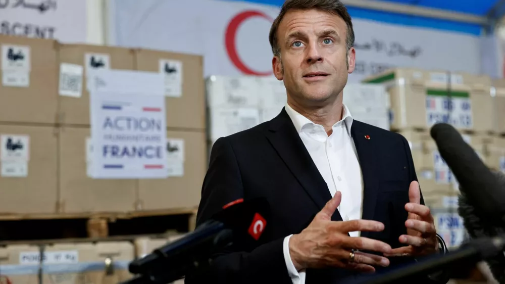 French President Emmanuel Macron talks to journalists during a visit at Egyptian Red Crescent warehouses storing aid for Gaza, in the Egyptian border town of El-Arish, Egypt, April 8, 2025. REUTERS/Benoit Tessier/Pool