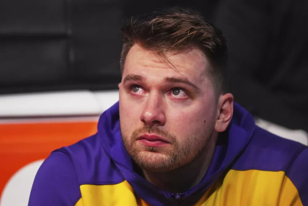 Los Angeles Lakers' Luka Doncic becomes emotional as he watches a video on the large video board that was a tribute to the former Dallas Mavericks player before an NBA basketball game in Dallas, Wednesday, April 9, 2025. (AP Photo/LM Otero)