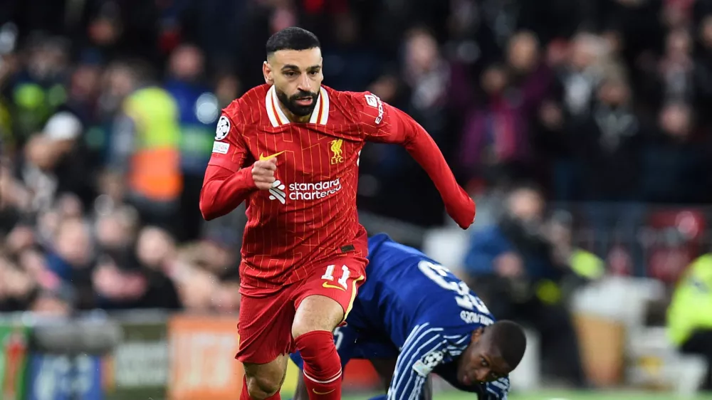 FILE PHOTO: Soccer Football - Champions League - Round of 16 - Second Leg - Liverpool v Paris St Germain - Anfield, Liverpool, Britain - March 11, 2025 Liverpool's Mohamed Salah in action with Paris St Germain's Nuno Mendes REUTERS/Peter Powell/File Photo