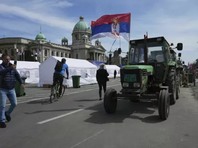 Tractors are parked in front of the Serbian parliament building ahead of a big counter-opposition protest rally planned to be staged over the weekend in downtown Belgrade, Serbia, Friday, April 11, 2025. (AP Photo/Darko Vojinovic)