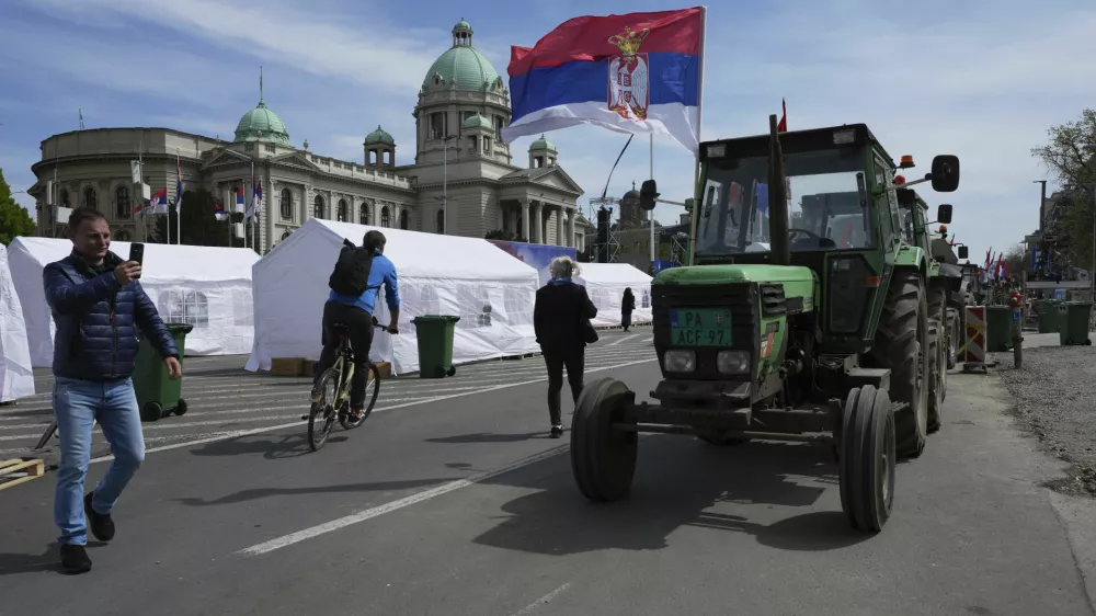Tractors are parked in front of the Serbian parliament building ahead of a big counter-opposition protest rally planned to be staged over the weekend in downtown Belgrade, Serbia, Friday, April 11, 2025. (AP Photo/Darko Vojinovic)