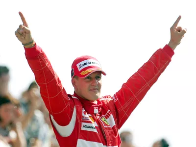 FILED - 10 September 2006, Italy, Monza: Formula 1 legend Michael Schumacher, then of Scuderia Ferrari, celebrates his victory at the Italian Grand Prix in Monza. Schumacher has signed a crash helmet which will be auctioned for Jackie Stewart's dementia charity. Photo: Gero Breloer/dpa