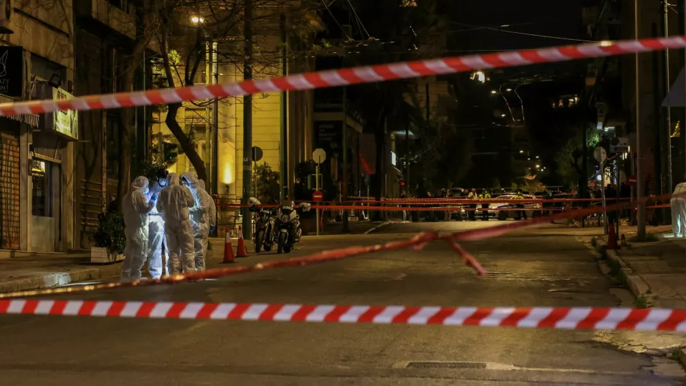 Forensics officers investigate the area of a bomb blast outside the Hellenic Train offices, in Athens, Greece, April 11, 2025. REUTERS/Stelios Misinas