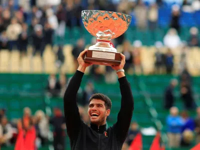 Tennis - ATP Masters 1000 - Monte Carlo Masters - Monte Carlo Country Club, Roquebrune-Cap-Martin, France - April 13, 2025 Spain's Carlos Alcaraz celebrates with the trophy after winning the Monte Carlo Masters REUTERS/Manon Cruz   TPX IMAGES OF THE DAY