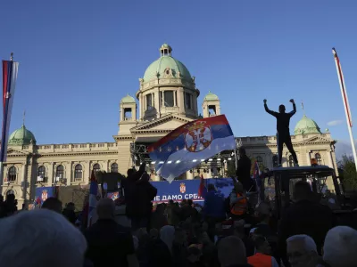 Supporters of Serbia's President Aleksandar Vucic gather during a rally in his support, apparently designed to counter student-led gatherings, in Belgrade, Serbia, Saturday, April 12, 2025. (AP Photo/Darko Vojinovic)