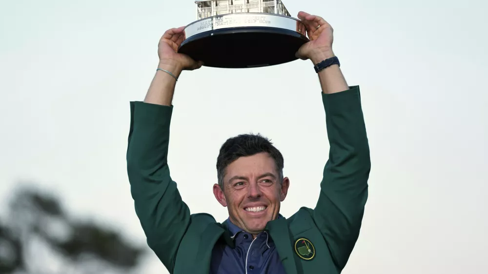 Winner Rory McIlroy, of Northern Ireland, holds the trophy at the Masters golf tournament, Sunday, April 13, 2025, in Augusta, Ga. (AP Photo/Ashley Landis)
