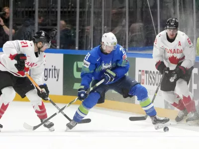 Ice Hockey - IIHF World Ice Hockey Championship 2023 - Group B - Slovenia v Canada - Arena Riga, Riga, Latvia - May 14, 2023 Slovenia's Jan Drozg in action with Canada's Scott Laughton REUTERS/Ints Kalnins
