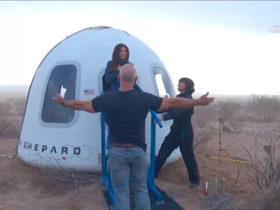 Jeff Bezos stands as Lauren Sanchez comes out of the capsule in which she, pop star Katy Perry, journalist Gayle King, and other participants, landed back on earth after blasting off into space on a Blue Origin rocket, as part of the New Shepard Mission NS-31, marking the first all-female flight crew in more than six decades, in West Texas, Texas, U.S., April 14, 2025, in this screen grab taken from a video. Blue Origin/Handout via REUTERS  THIS IMAGE HAS BEEN SUPPLIED BY A THIRD PARTY. NO RESALES. NO ARCHIVES. MANDATORY CREDIT   TPX IMAGES OF THE DAY