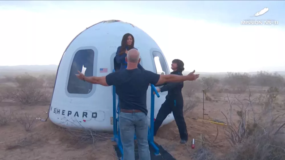 Jeff Bezos stands as Lauren Sanchez comes out of the capsule in which she, pop star Katy Perry, journalist Gayle King, and other participants, landed back on earth after blasting off into space on a Blue Origin rocket, as part of the New Shepard Mission NS-31, marking the first all-female flight crew in more than six decades, in West Texas, Texas, U.S., April 14, 2025, in this screen grab taken from a video. Blue Origin/Handout via REUTERS  THIS IMAGE HAS BEEN SUPPLIED BY A THIRD PARTY. NO RESALES. NO ARCHIVES. MANDATORY CREDIT   TPX IMAGES OF THE DAY