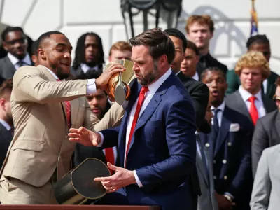 U.S. Vice President JD Vance drops the trophy, as he and President Donald Trump (not pictured) meet the Ohio State University 2025 College Football National Champions, at the White House, in Washington, D.C., U.S., April 14, 2025. REUTERS/Evelyn Hockstein