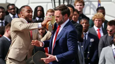 U.S. Vice President JD Vance drops the trophy, as he and President Donald Trump (not pictured) meet the Ohio State University 2025 College Football National Champions, at the White House, in Washington, D.C., U.S., April 14, 2025. REUTERS/Evelyn Hockstein