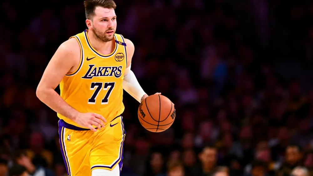 FILE PHOTO: Apr 11, 2025; Los Angeles, California, USA; Los Angeles Lakers guard Luka Doncic (77) moves the ball against the Houston Rockets during the first half at Crypto.com Arena. Mandatory Credit: Jonathan Hui-Imagn Images/File Photo